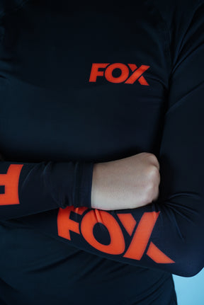 Rash Guard Jiu-Jitsu Feminina FOX FW Preta Manga Longa (Logo Laranja) UV 50+